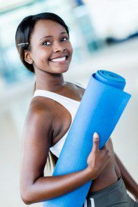 How to Buy a Yoga Mat - Woman Holding a Yoga Mat