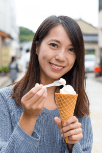 Woman eating ice cream in a cone